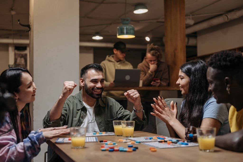 A group of friends playing a board game indoors, enjoying fun and laughter.