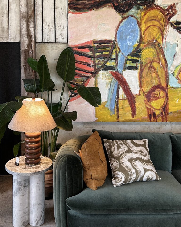 Cozy living room featuring a spring home reset with colored couch and wall art