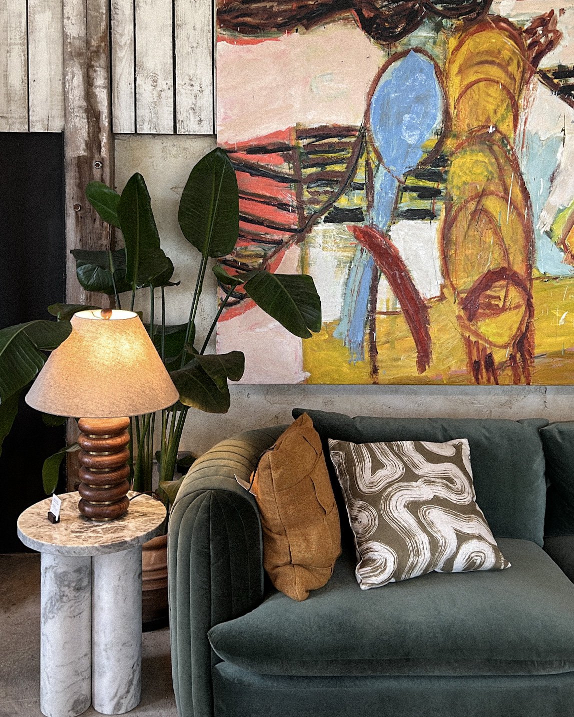 Cozy living room featuring a spring home reset with colored couch and wall art