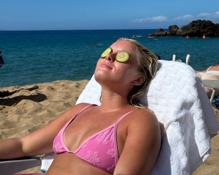 woman sun bathing on the beach on a hot spring day