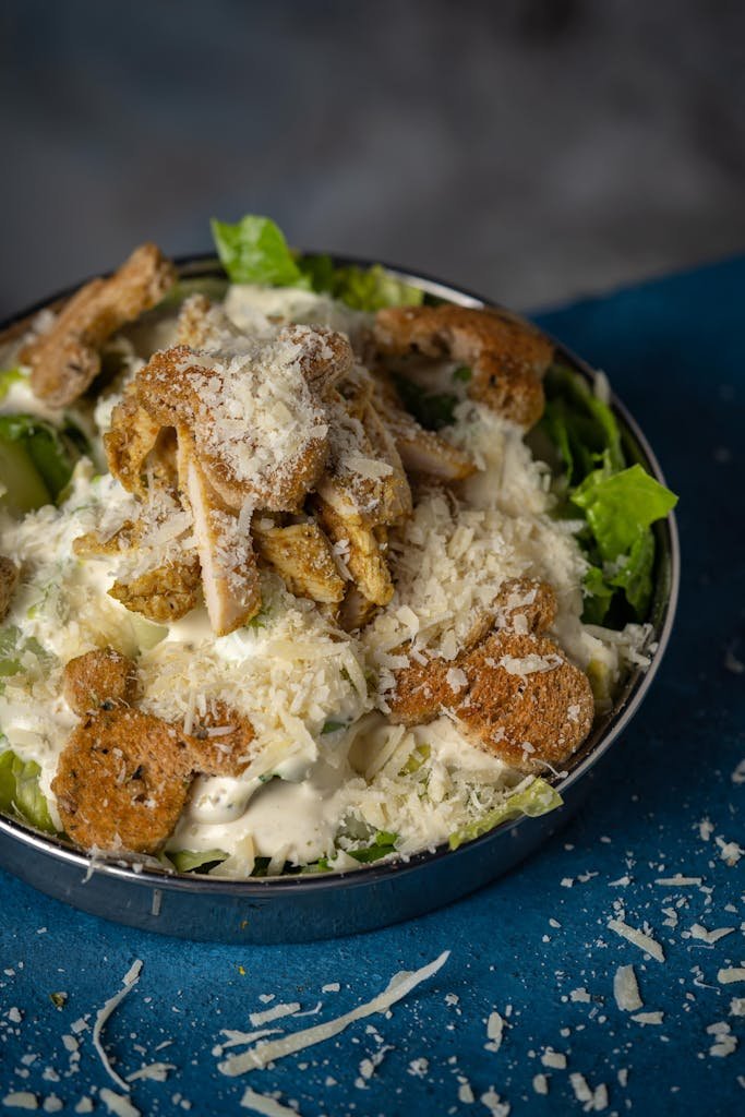 Mouthwatering Caesar salad topped with grilled chicken and freshly grated Parmesan cheese.