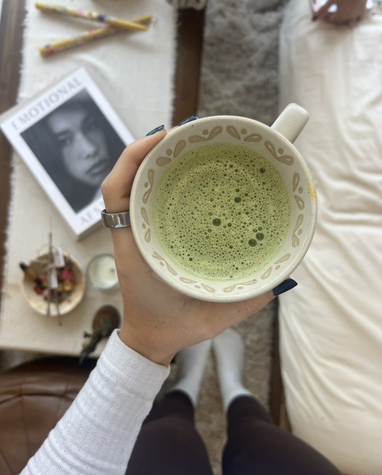 woman holding a mug of matcha latte representing a spring wellness reset