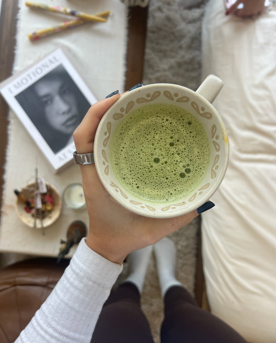woman holding a mug of matcha latte representing a spring wellness reset
