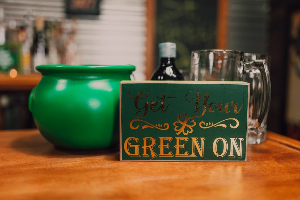 St. Patrick's Day themed sign with festive decor on a wooden table.