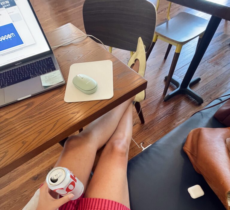 Working on a first website from a laptop in a casual coffee shop setup