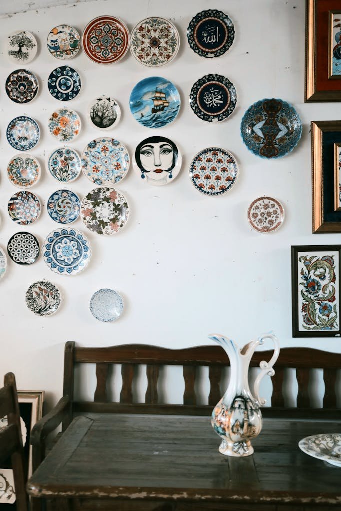 Artistic display of colorful vintage ceramic plates on a rustic wooden table.