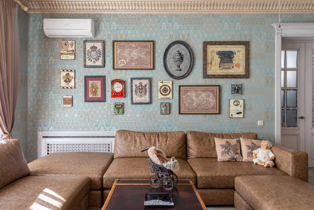 Cozy vintage-style living room with a brown sofa and an art-filled wall, creating a warm, elegant ambiance.