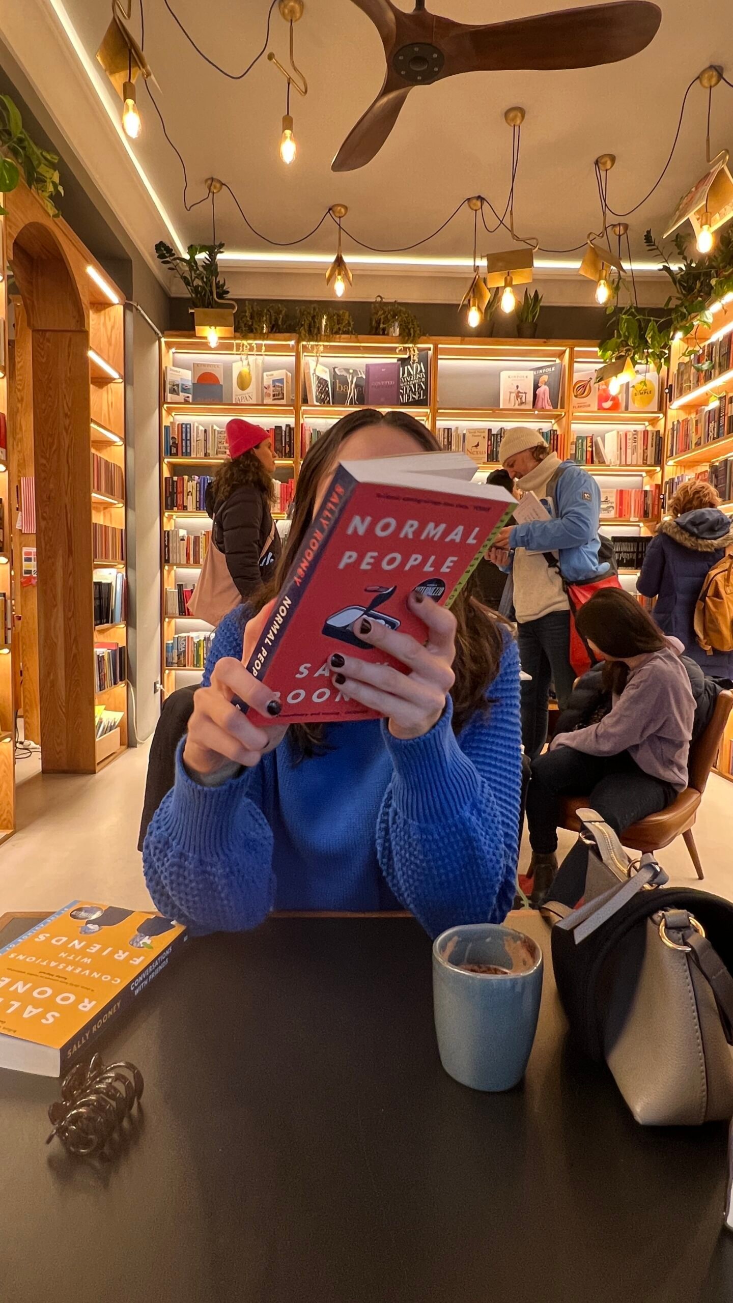 Woman choosing to read a book after scrolling too much