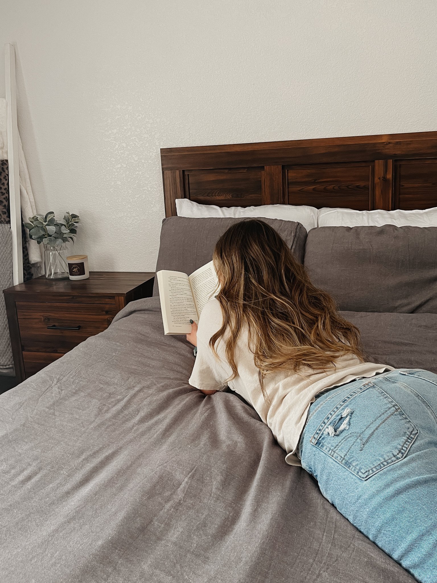 Woman reading a book in her bed in the morning